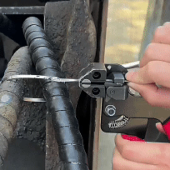 Cable tie gun tensioning and cutting a stainless tie